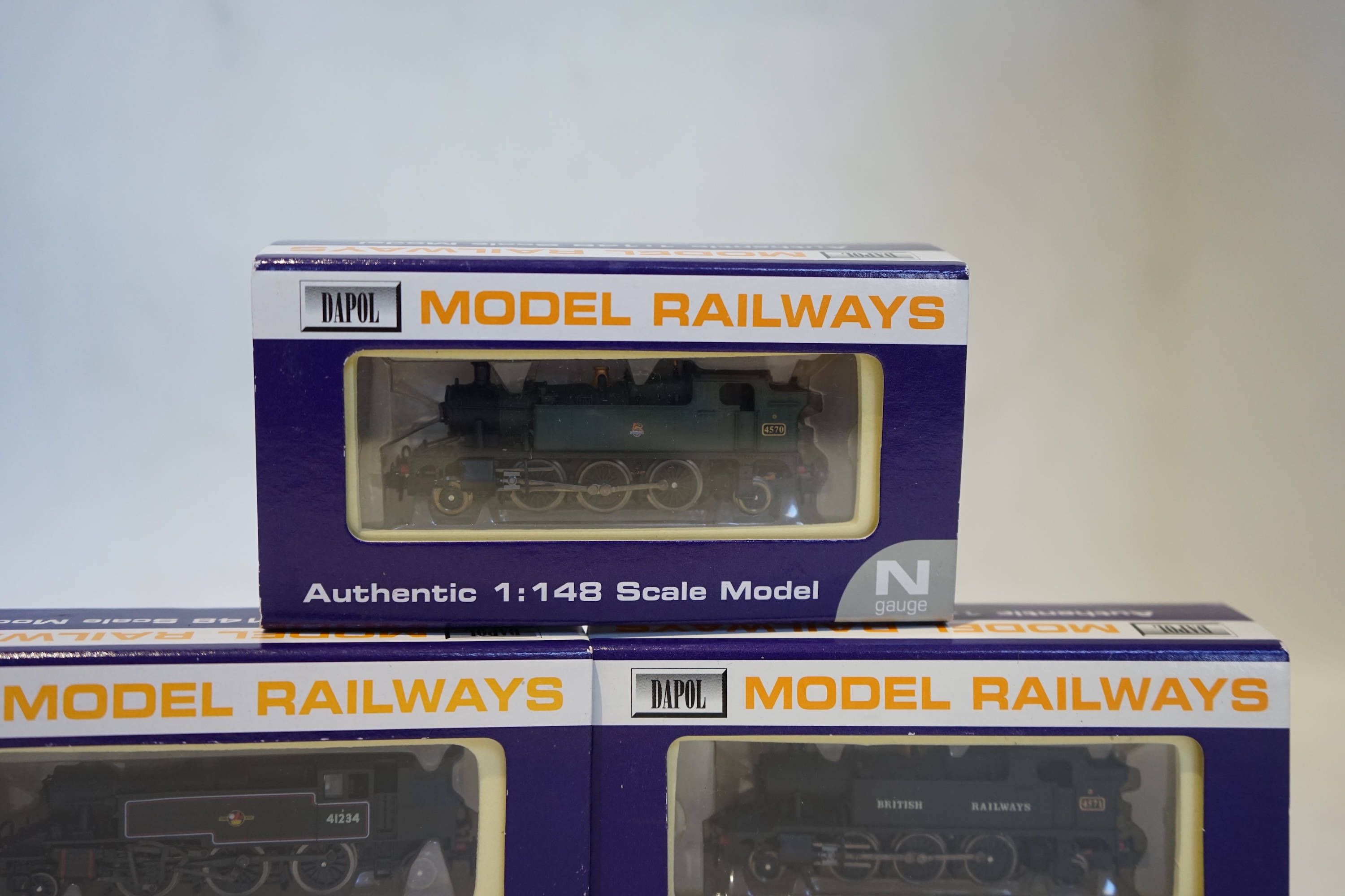 Three boxed Dapol N gauge railway BR tank locomotives; an Ivatt 2-6-2T, 41234 (ND-061A), a Class 45xx, 4571 (ND-024), and a Class 45xx, 4570 (ND-013). Condition - good.